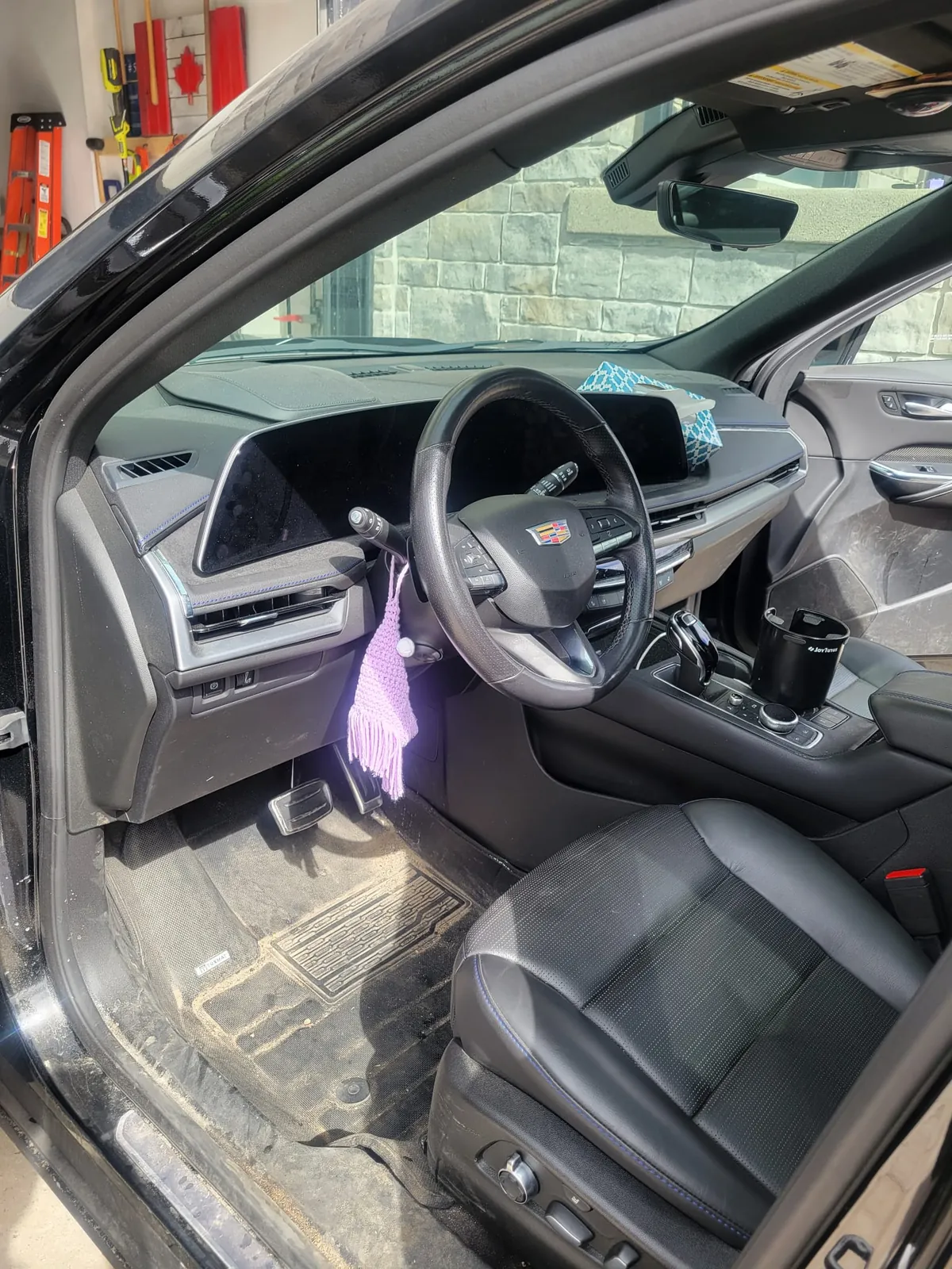 Dusty dash and driver mat before an interior detail. Exclsive Detailing, mobile detailing in Durham Region.