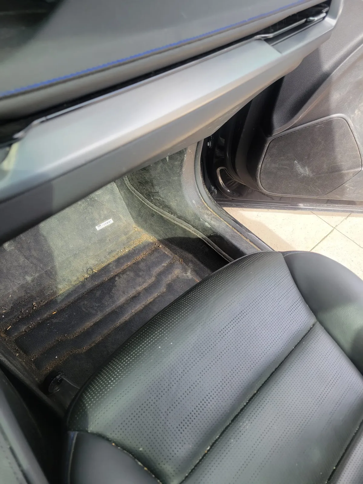 Passenger footwell packed with grit before cleaning. Exclsive Detailing, mobile detailing in Durham Region.