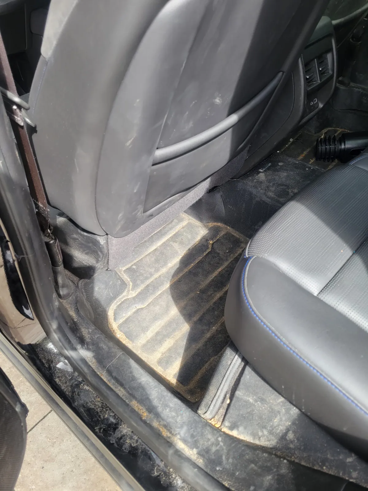 Rear floor mat packed with salt and dirt. Exclsive Detailing, mobile detailing in Durham Region.