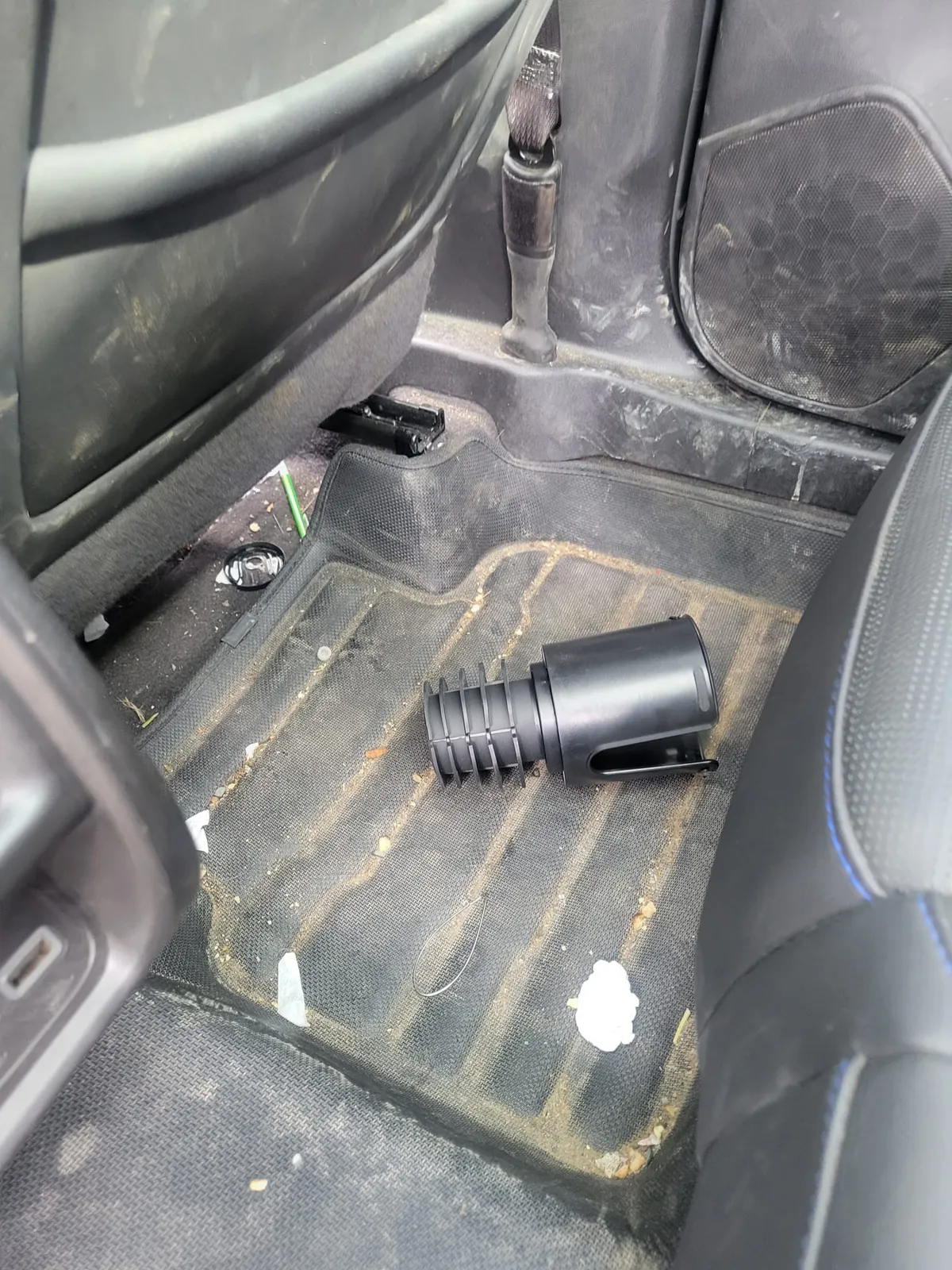 Rear floor covered in crumbs and debris. Exclsive Detailing, mobile detailing in Durham Region.