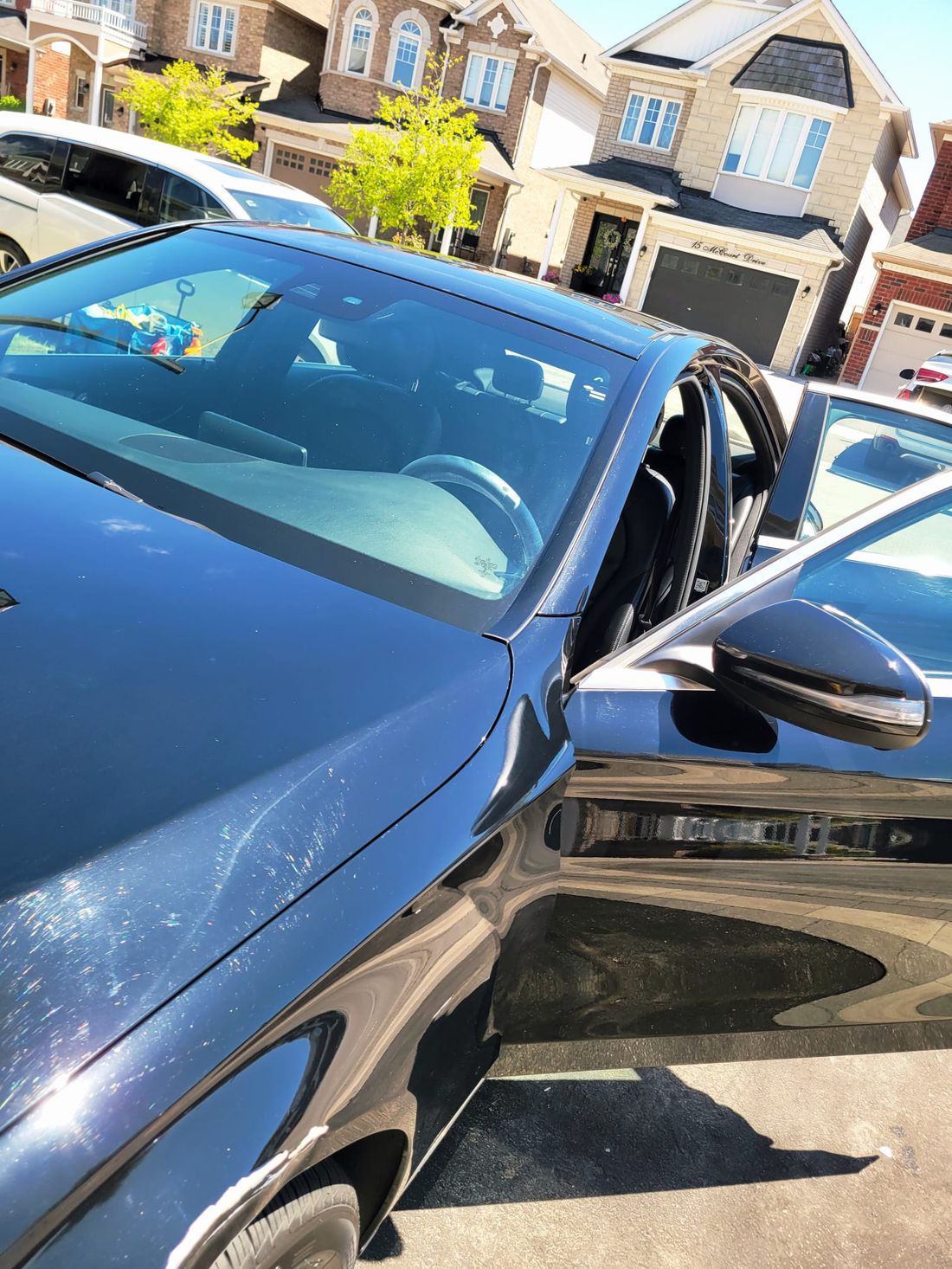Glossy black sedan exterior after a mobile detail in a Durham Region driveway